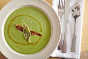 Broccoli soup topped with crispy fried pancetta and fried sage. Photo by Shea Evans