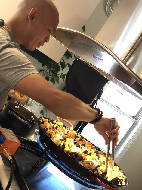 Tim Meevasin prepares paella