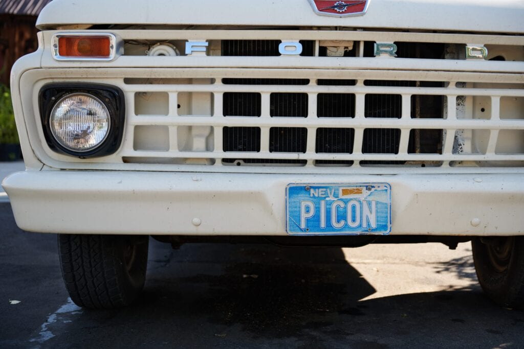 An old Nevada license plate on a vintage Ford truck