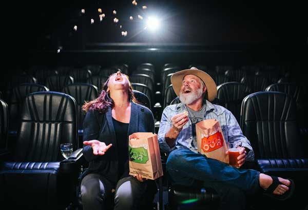 Melissa and Steven Siig, co-owners of the Tahoe Art Haus & Cinema, play with their movie house’s non-GMO popcorn