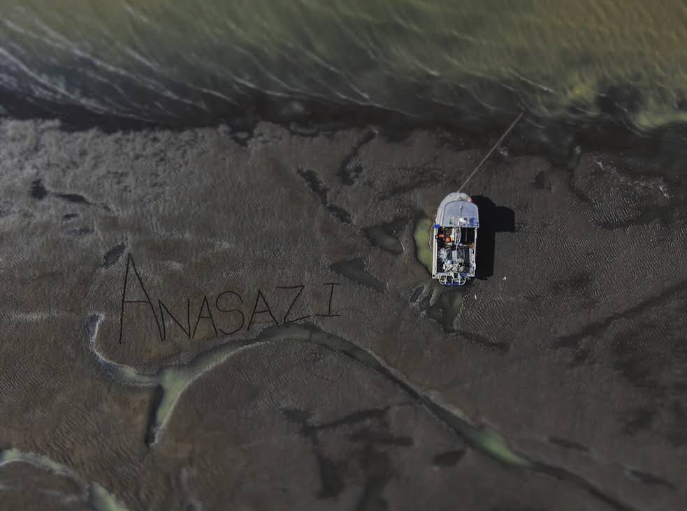 Arial shot of Captain Nick Lee's fishing vessel, the Anasazi. Its name was written in the muddy delta by crew members. Photo by Austin Breckinridge