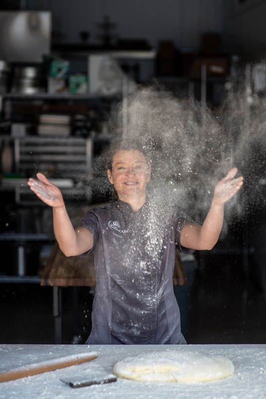 Daniella Rinaldi, co-owner of Sierra Bakehouse in Truckee, tosses flour while baking