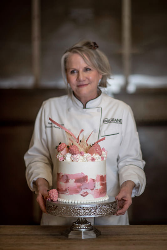 Patti Dellamonica-Bauler, executive pastry chef at Grand Sierra Resort in Reno, displays her lemon buttermilk cake with strawberries and a white chocolate vanilla bean buttercream
