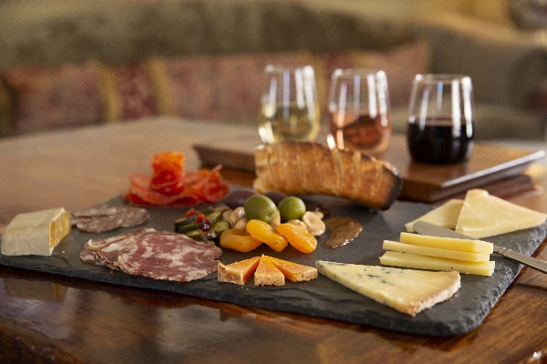 A charcuterie board with wines