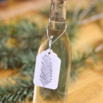 A bottle of Douglas Fir simple syrup prepared by Brooke Walshaw, with a hand stamped gift tag. Photo by Lou Manna