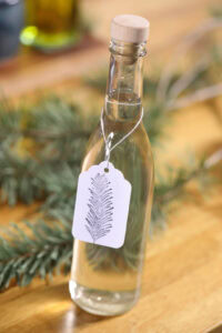 A bottle of Douglas Fir simple syrup prepared by Brooke Walshaw, with a hand stamped gift tag. Photo by Lou Manna