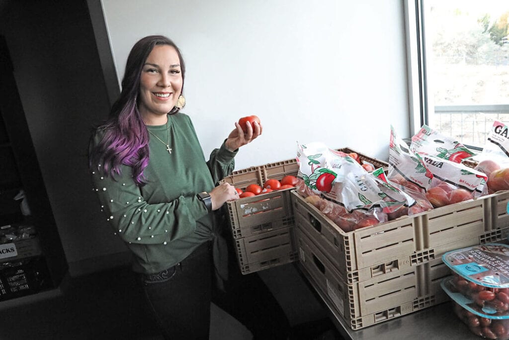 Lunt, an alumnus of STEP2, checks the fresh produce used to prepare healthy meals at the facility
