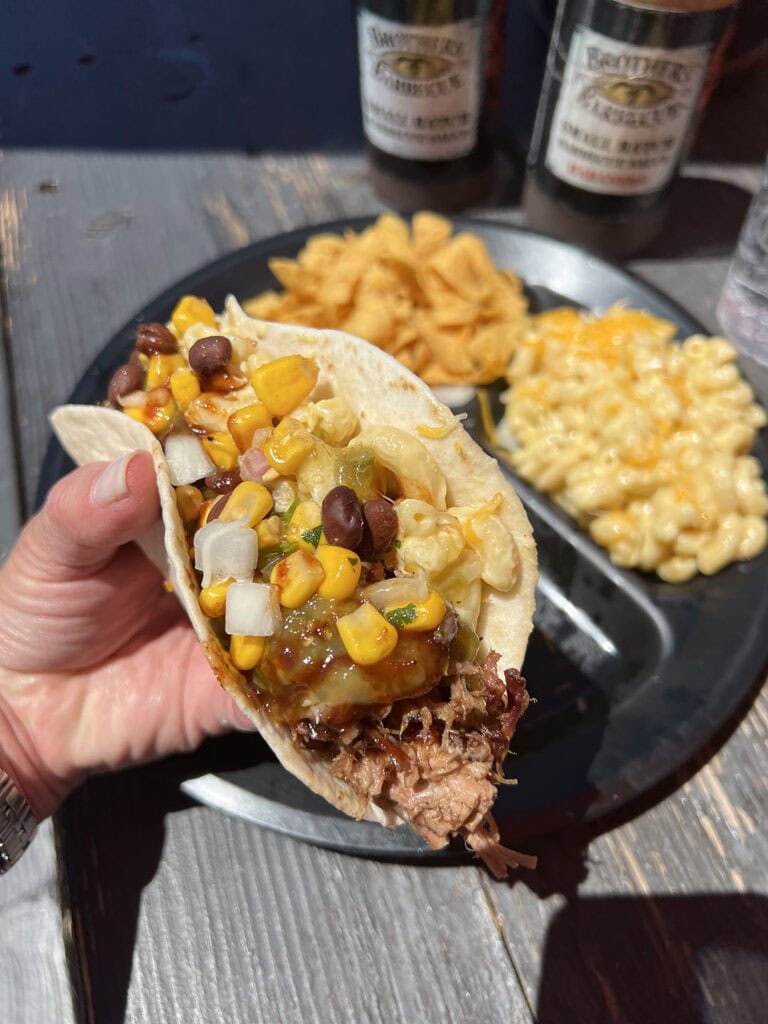 Brisket taco topped with salsa, corn and black bean relish, and mac ’n’ cheese at Brothers Barbecue. Photo by Jaci Goodman