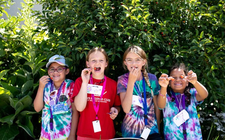 A group of students with the Boys & Girls Club participate in FARMily’s summer camp gardening program