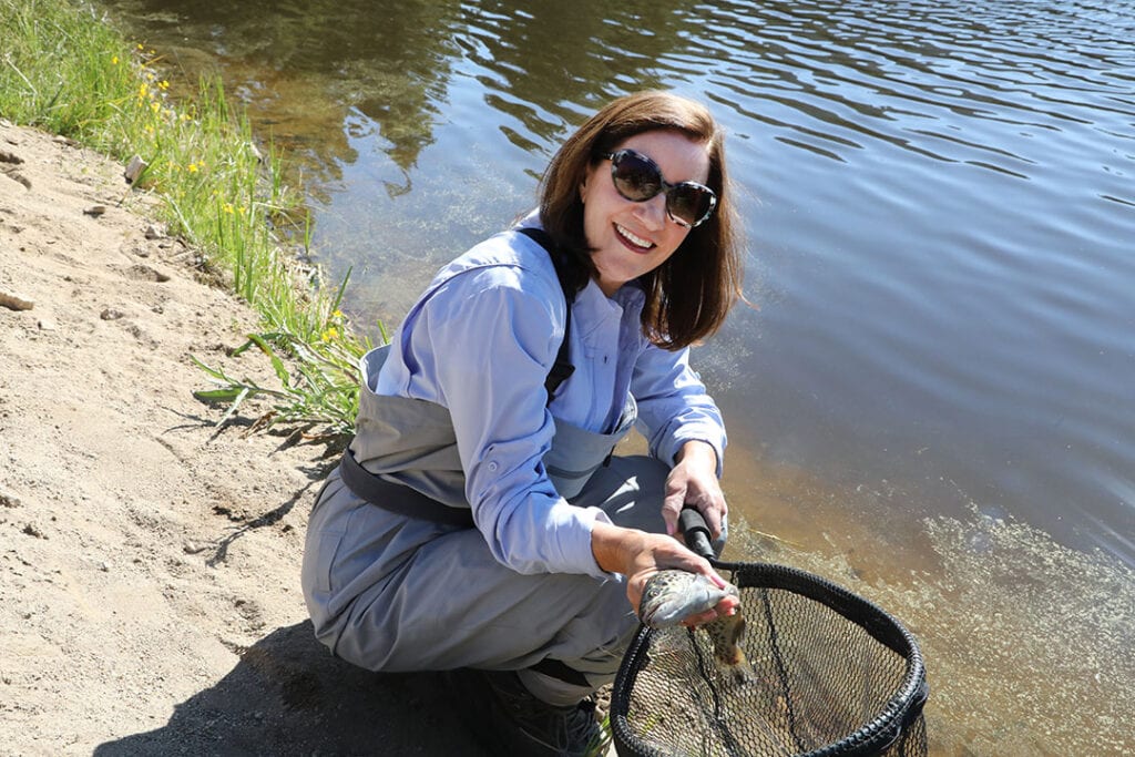 East shows off the tiger fish sheโs caught