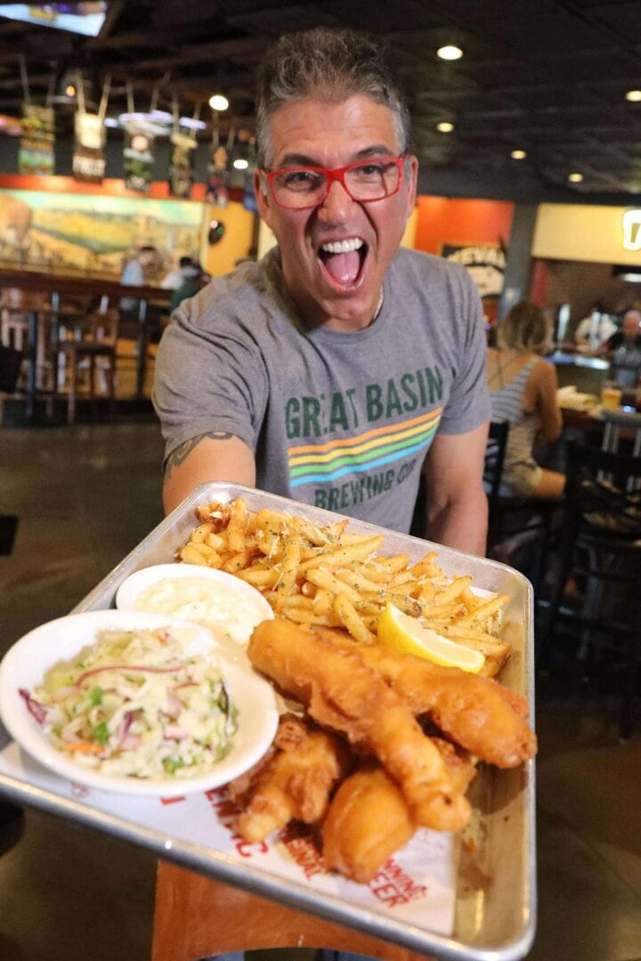 Mark Estee serves up fish ’n’ chips at Great Basin Brewing Co. Photo by Lou Manna