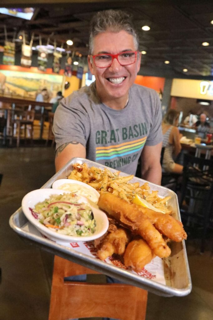 Mark Estee with Local Food Group holds a fish and chips platter