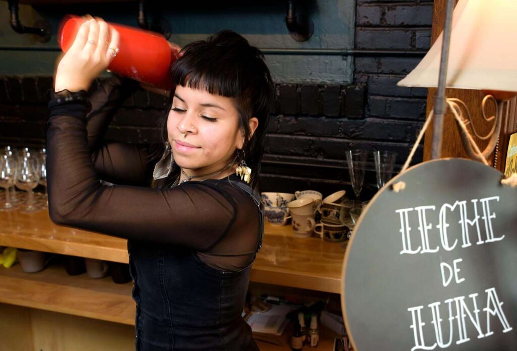 Jess Trujillo-Flynn shakes the como la flor elixir made with hibiscus and spices that tastes like a red chai