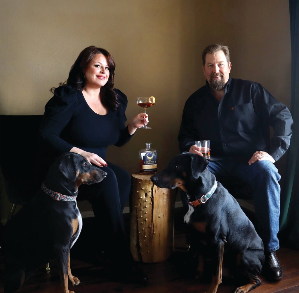 Lauren and Joe Luby, with Dobermanns, Sage and Scarlett, for whom the distillery is named