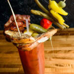 Chapel Tavern's bloody mary is topped with a grilled cheese sandwich, bacon, pickles, peppers, asparagus, string beans, an olive, and a lemon wedge. Photo by Mike Higdon