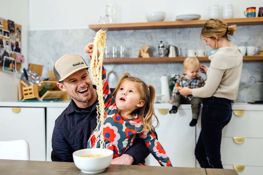 Chris McNamara and his daughter, Mila, 3, play with ramen noodles. Photo by Jen Schmidt