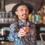 DOPO bartender Bryan McAuliffe presents a Negroni. Photo by Shaun Hunter