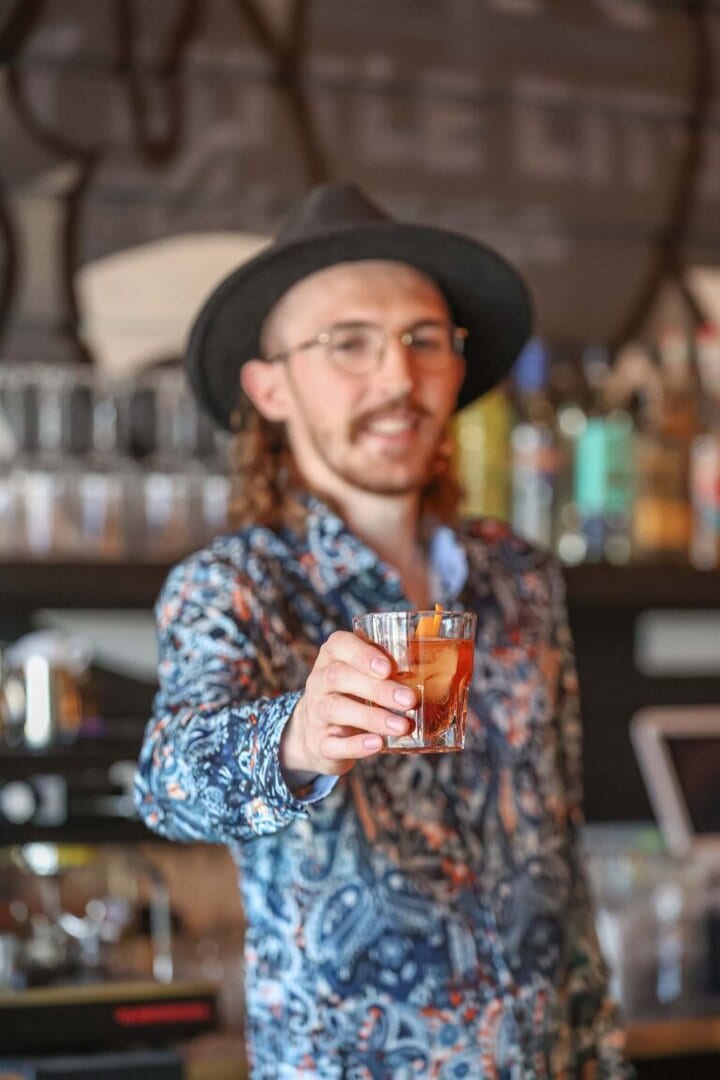 DOPO bartender Bryan McAuliffe presents a Negroni. Photo by Shaun Hunter