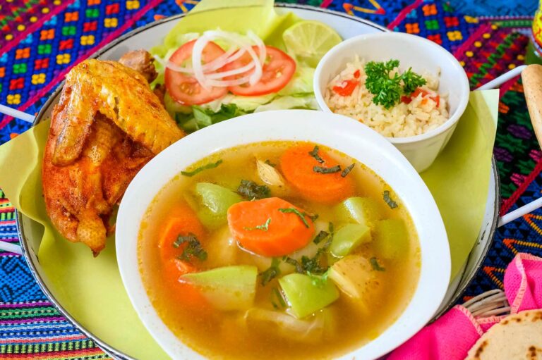 Panaderia Mi Lida Guatemala serves caldo de pollo, a chicken soup made with thick-cut carrots, potatoes, and herbs, with a side of rice, quarter chicken, and house-made Guatemalan tortillas