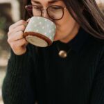 Brooke Walshaw sips fire cider. Photo by Ashley Robison