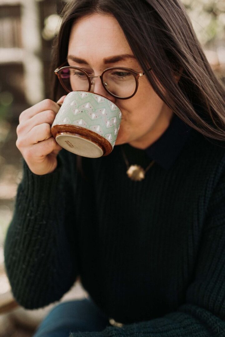 Brooke Walshaw sips fire cider. Photo by Ashley Robison