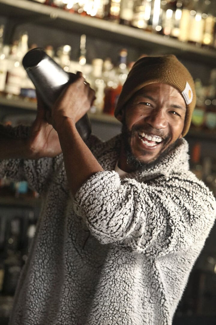 KJ Flippen, owner of The Z Bar, shakes up the makings of a cocktail before adding Champagne. Photo by Lou Manna