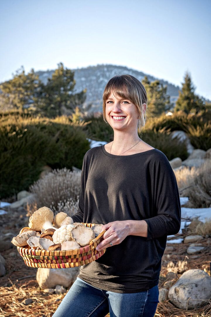 Sarah Catalano, part of the Nevada Department of Agriculture’s Women’s Farm2Food Accelerator Program, holds a basket of lion’s mane, king trumpet, oyster, and shiitake mushrooms she grows on the farm she started with her husband, Matt, called Rooted Farm