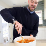 Keenan Polan mixes his sweet potato mash with bacon and jalapeños. Photo by Mike Higdon