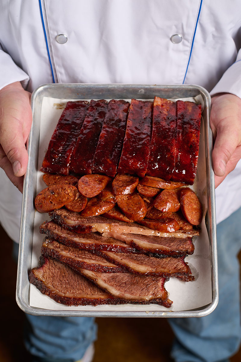 Barbecue feast, featuring house-smoked ribs, hot links, and brisket, at BJ’s Nevada Barbecue Co. Photo by Shea Evans