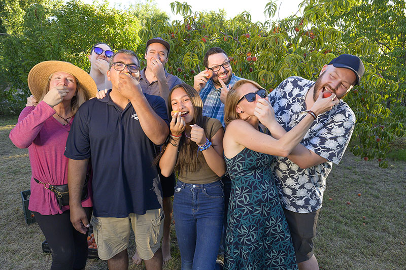 The family gathers in front of the farm's peach trees. From left, Karen Nichols, Brynna Nichols, Louie Adame, Andy Sieracki, Adrienne Adame, Justin Norton, Maggie Nichols, and Brad Nichols