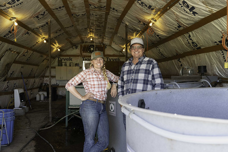 Emily and Steven Fulstone stand in the Fulstone Ranches’ worm shed