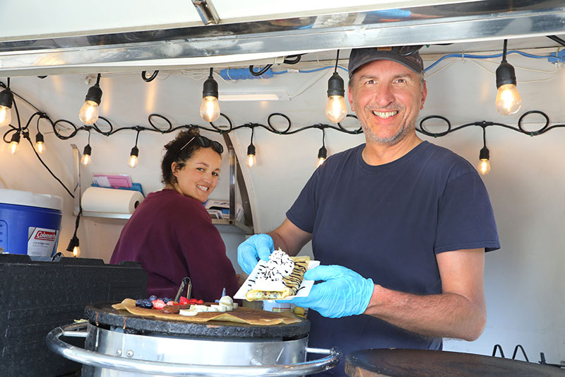 Olivier Bessaignet and his sister-in-law, Alex serve crêpes at the Riverside Farmers Market in Idlewild Park