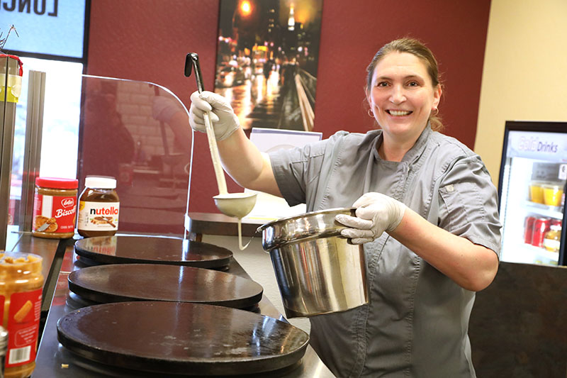 Jana Sikk, owner of Kaffé Crepe, ladles batter onto a crêpe griddle