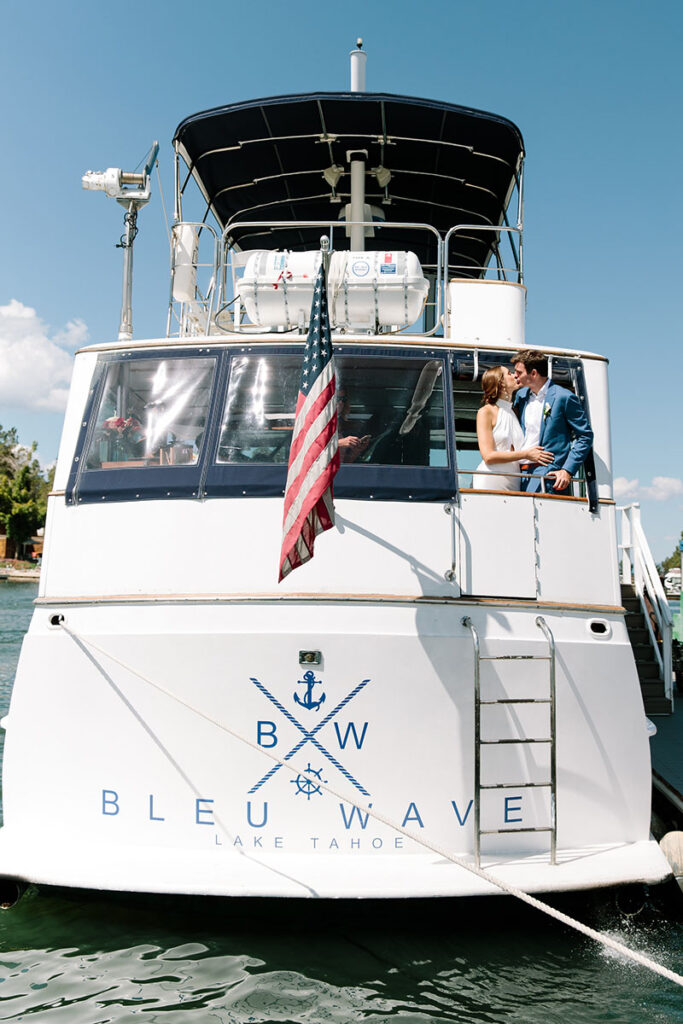 Newlyweds Jen O’Neil and Patrick Mullane steal a kiss onboard the Tahoe Bleu Wave. Dress by Jenny Yoo. Suit by Bonobos. Photo by Courtney Aaron