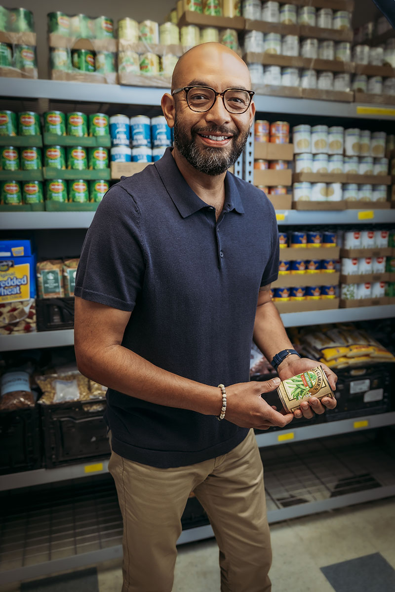 Community Health Alliance CEO Oscar Delgado in the organization’s food pantry