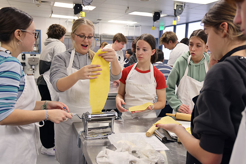 Eighth graders from Carson Valley and Pau-Wa-Lu middle schools try their hands at cooking in Sarah Crofton’s culinary arts kitchen as part of Douglas High School’s CTE Open House, which gives incoming students a taste of programs they can enroll in next year. Photo courtesy of Douglas County School District