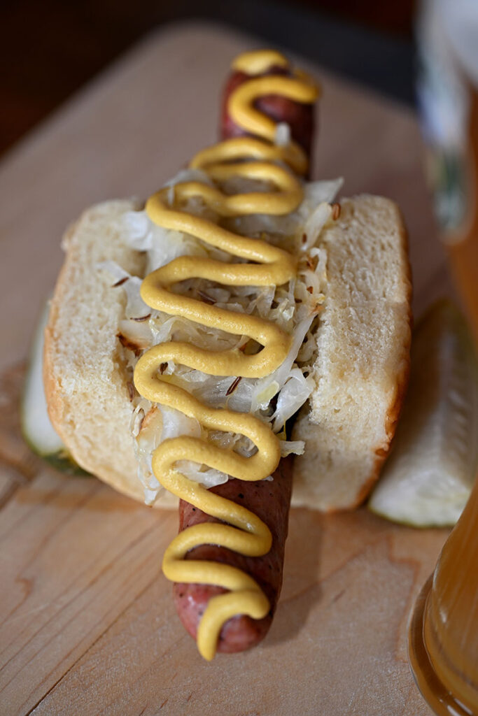 A signature wurst, the Prost brat, with sauerkraut and mustard.