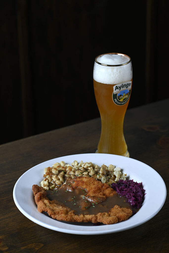 Prost’s German plate, a schnitzel and gravy with spaetzle and rotkohl (red cabbage) and a glass of the German beer Weihenstephaner