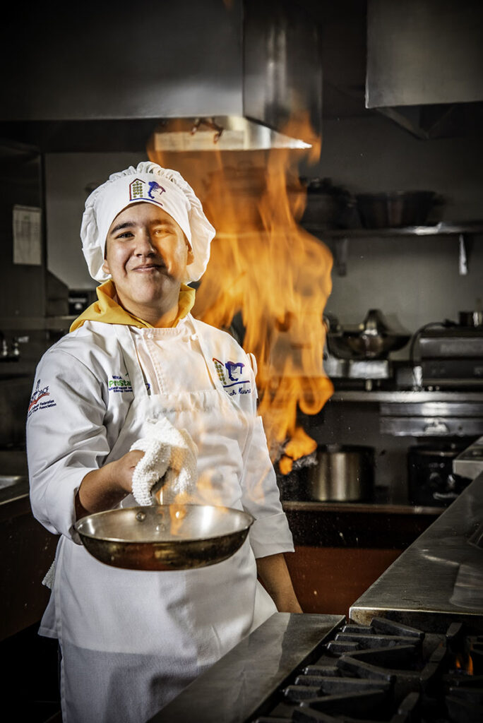 Noah Musni, a culinary student at Academy of Arts, Careers and Technology in Reno, prepares bananas foster. Photo by Donna Victor