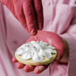 Ciarra Melvin adds sparkly finishing touches to a cookie. Photo by Donna Victor