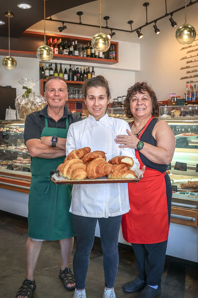 From left, Claudio, Melissa, and Giuseppa Iturriaga present a tray of croissants at Dolce Caffé in Reno