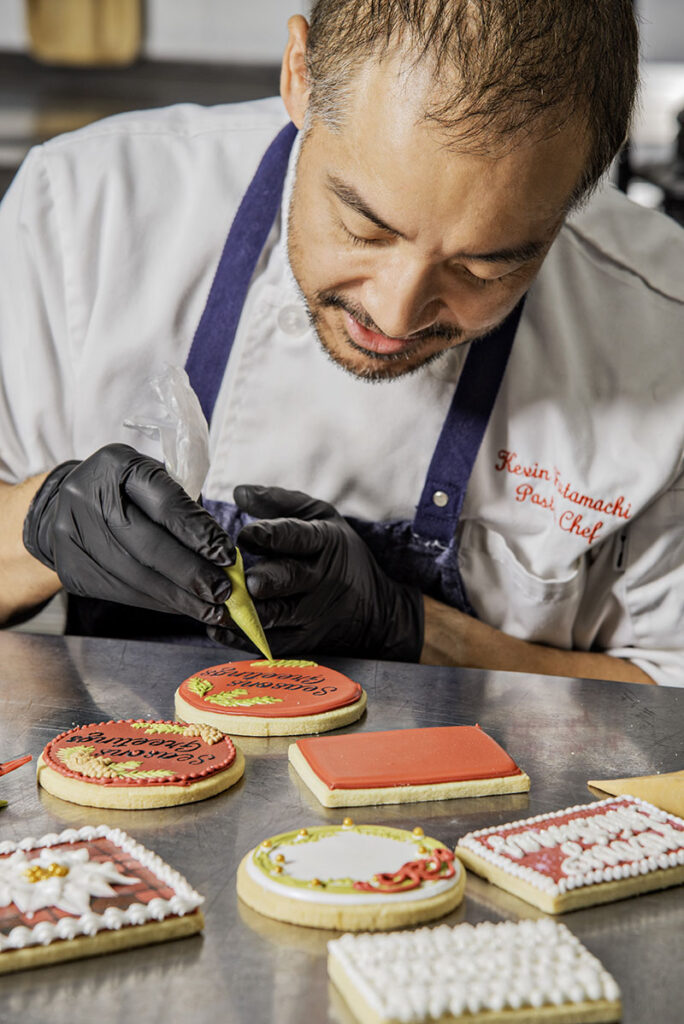 Futamachi uses stencils and piping to decorate his rolled sugar cookies