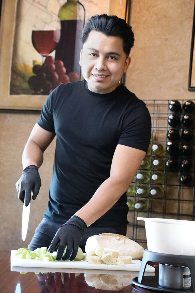 Sous chef Leonardo LaCruz cuts apples for the fondue at Napa Sonoma