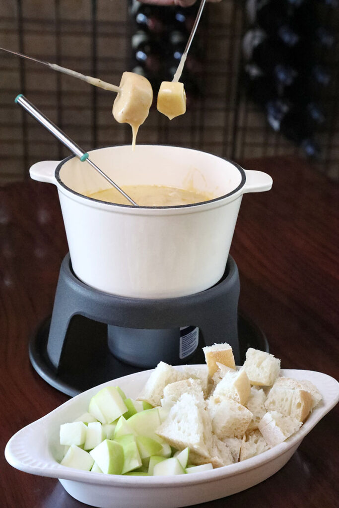 Cheese fondue at Napa Sonoma is served with chunks of bread and apple