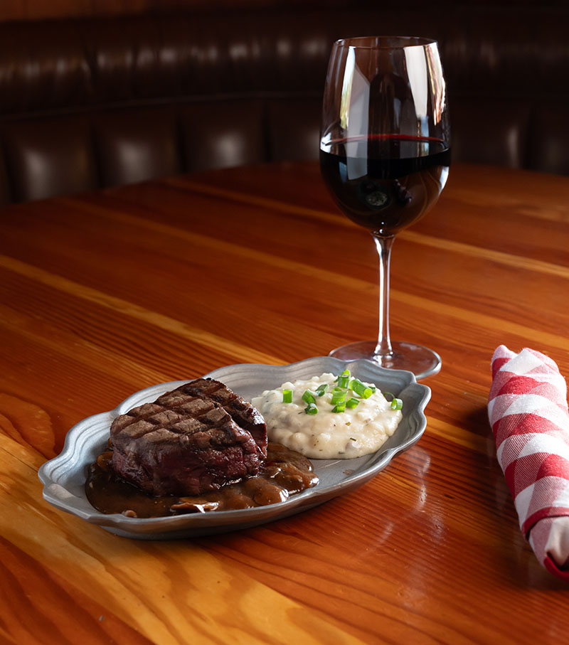 Filet mignon in cabernet-mushroom sauce with garlic mashed potatoes and a glass of red wine from the restaurant’s collection of roughly 70 bottles