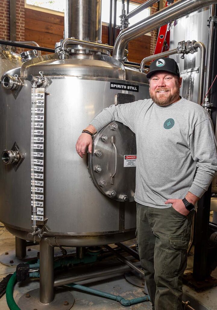 10 Torr head distiller Thomas Lee stands beside the spin still, the distillery’s most-used piece of equipment