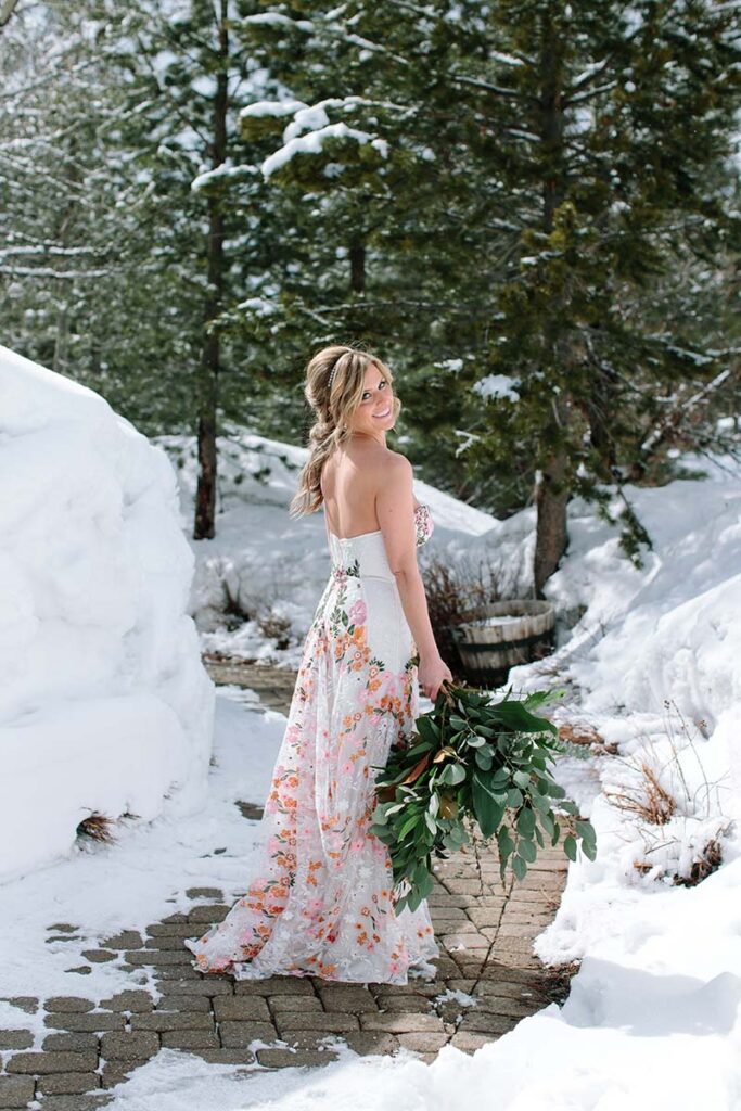 Liz Oldernburg poses in her gown by Swoon Bridal before her wedding at PlumpJack Inn. Hair and makeup by Kiss and Makeup. Florals by Awesome Blossom. Planning by Vista Events. Photo by Courtney Aaron