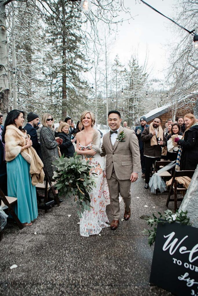 Liz Oldernburg and Jack Valera celebrate their nuptials at PlumpJack Inn. Dress by Swoon Bridal. Suit by Studio Suits. Hair and makeup by Kiss and Makeup. Florals by Awesome Blossom. Planning by Vista Events. Photo by Courtney Aaron