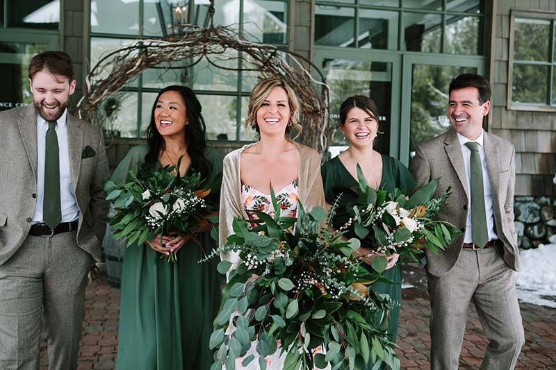 Bride Liz Oldernburg with her wedding party at PlumpJack Inn in Olympic Valley. Dress by Swoon Bridal. Bridesmaid dresses by Birdy Grey. Suits by Studio Suits. Hair and makeup by Kiss and Makeup. Florals by Awesome Blossom. Planning by Vista Events. Photo by Courtney Aaron