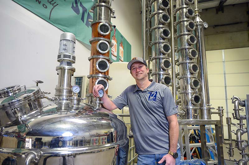 Eric Roe, co-founder of 72 Mile, stands with his still in his Reno warehouse. Photo by Mike Higdon